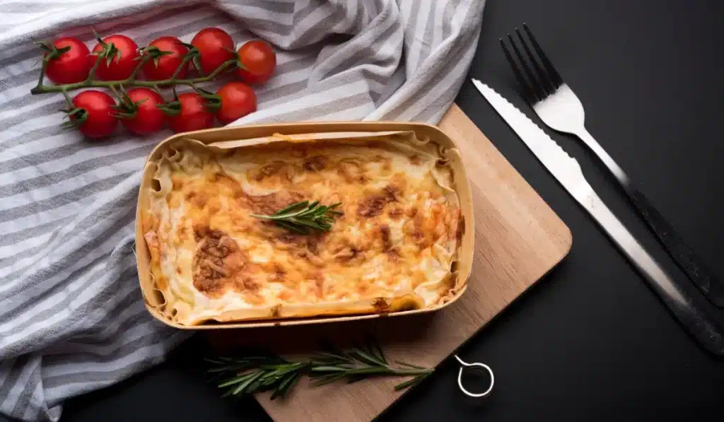 high angle view of tablecloth; fresh ingredient and delicious lasagna