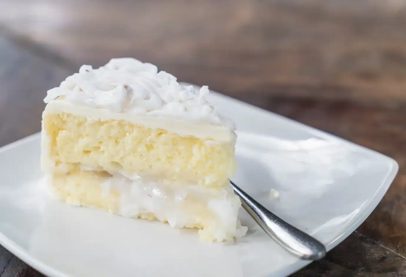 coconut cake on a plate and a spoon