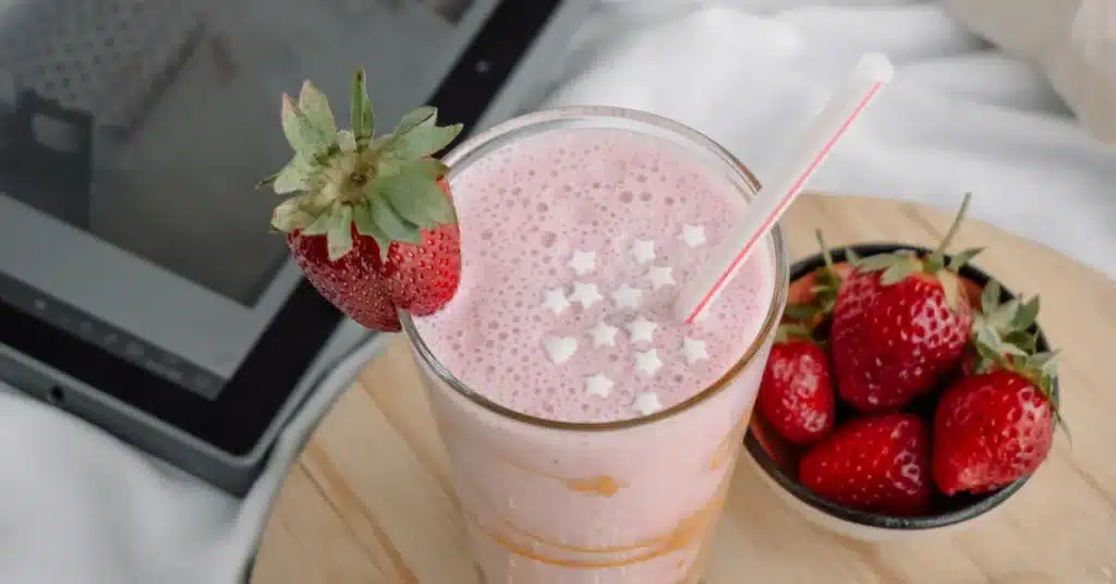 Grimace shake with a tablet on a bed