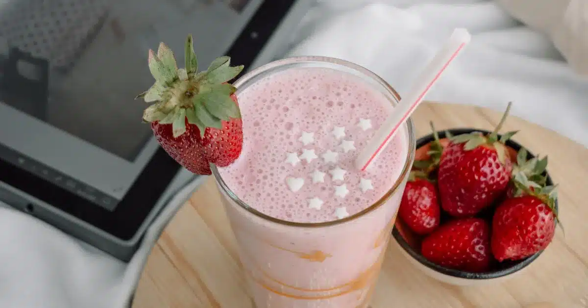 Grimace shake with a tablet on a bed