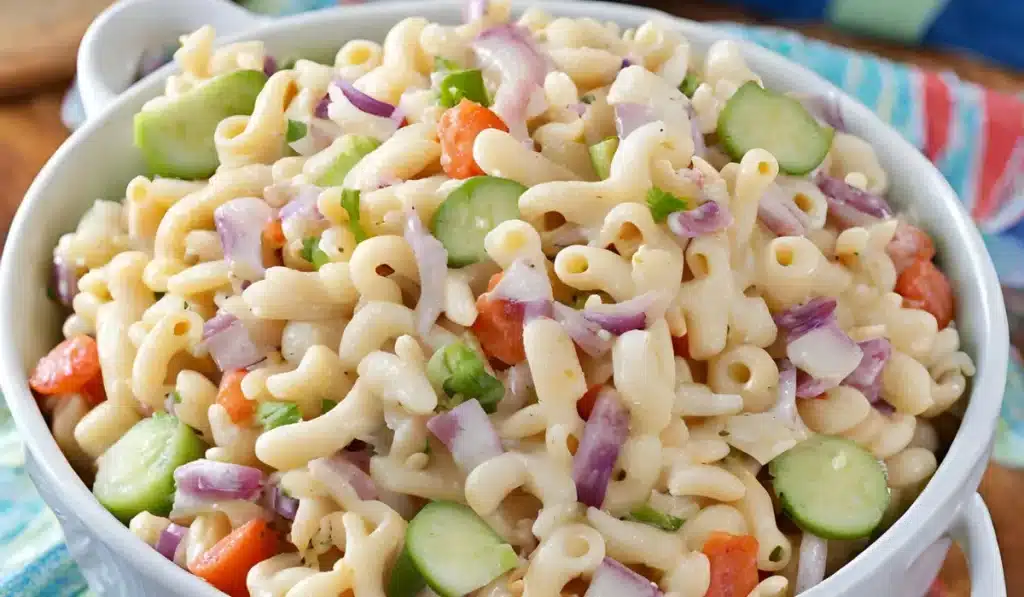 A bowl of Zippy's macaroni salad from Hawaii, made with macaroni noodles, onions, carrots, cucumbers, and a creamy mayonnaise dressing.